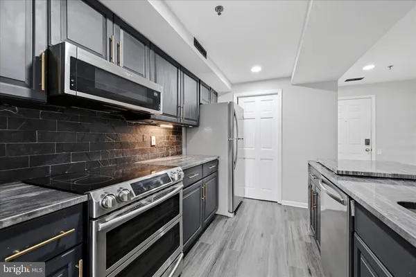 a kitchen with a stove microwave and sink