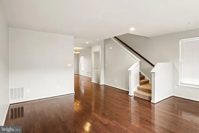 a view of a hallway with wooden floors