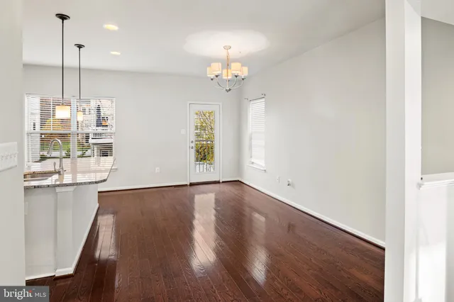 a view of a kitchen with wooden floor and windows
