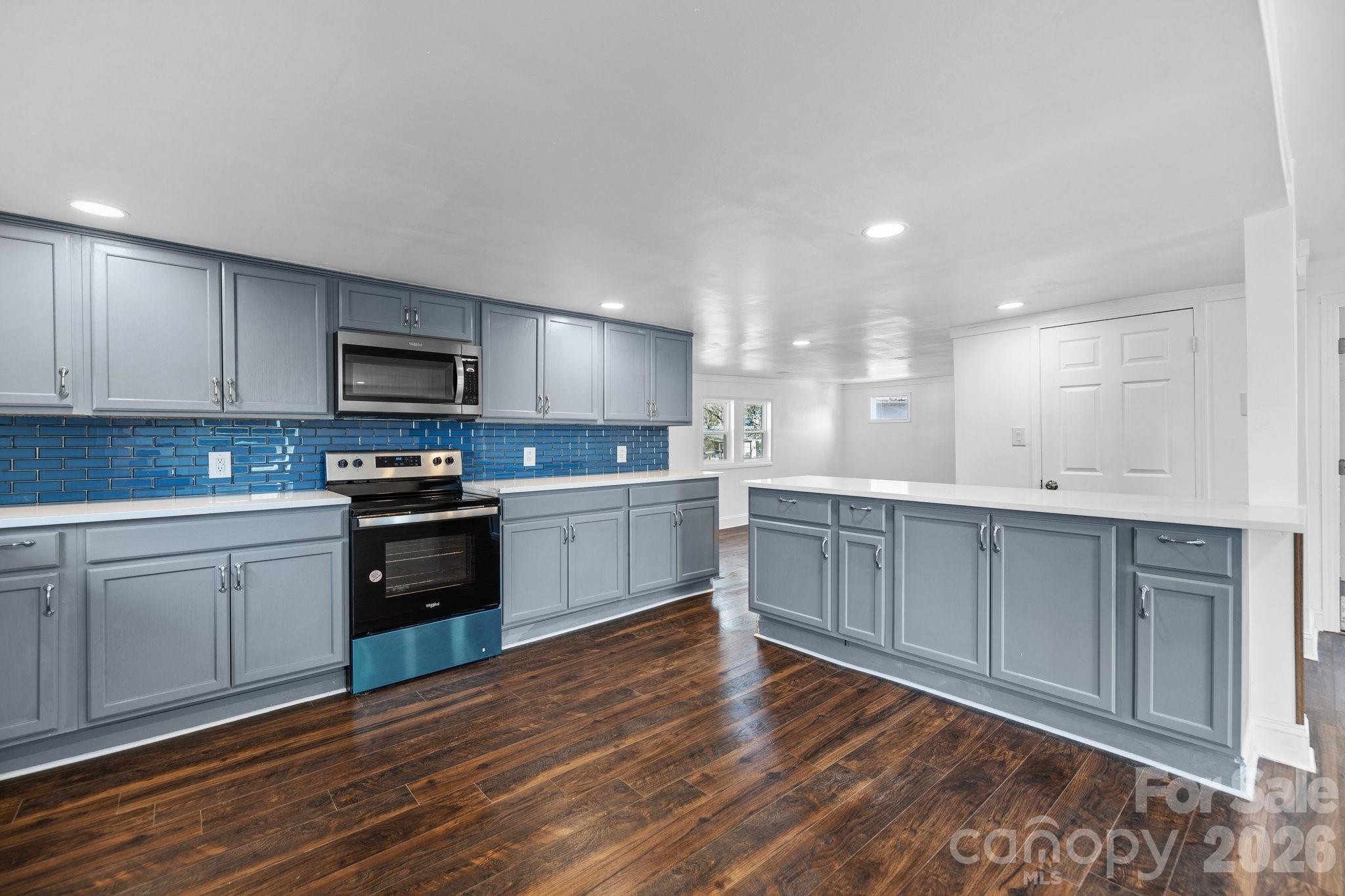 306 Ridge Street Stanley, NC 28164 - Photo 3 of 44 a kitchen with a sink cabinets and stainless steel appliances