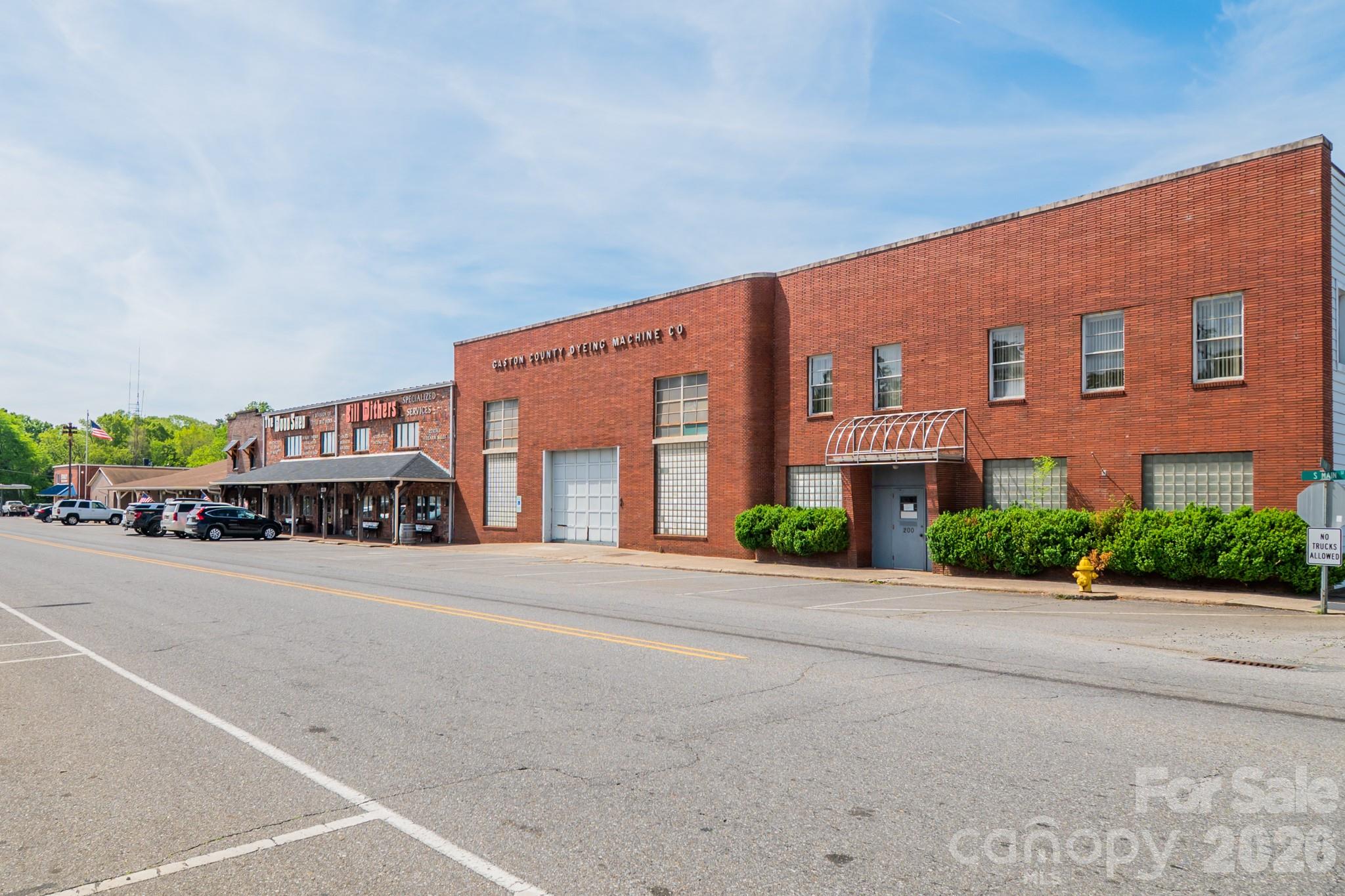 306 Ridge Street Stanley, NC 28164 - Photo 41 of 44 front view of a building with a street and a car parked on the road