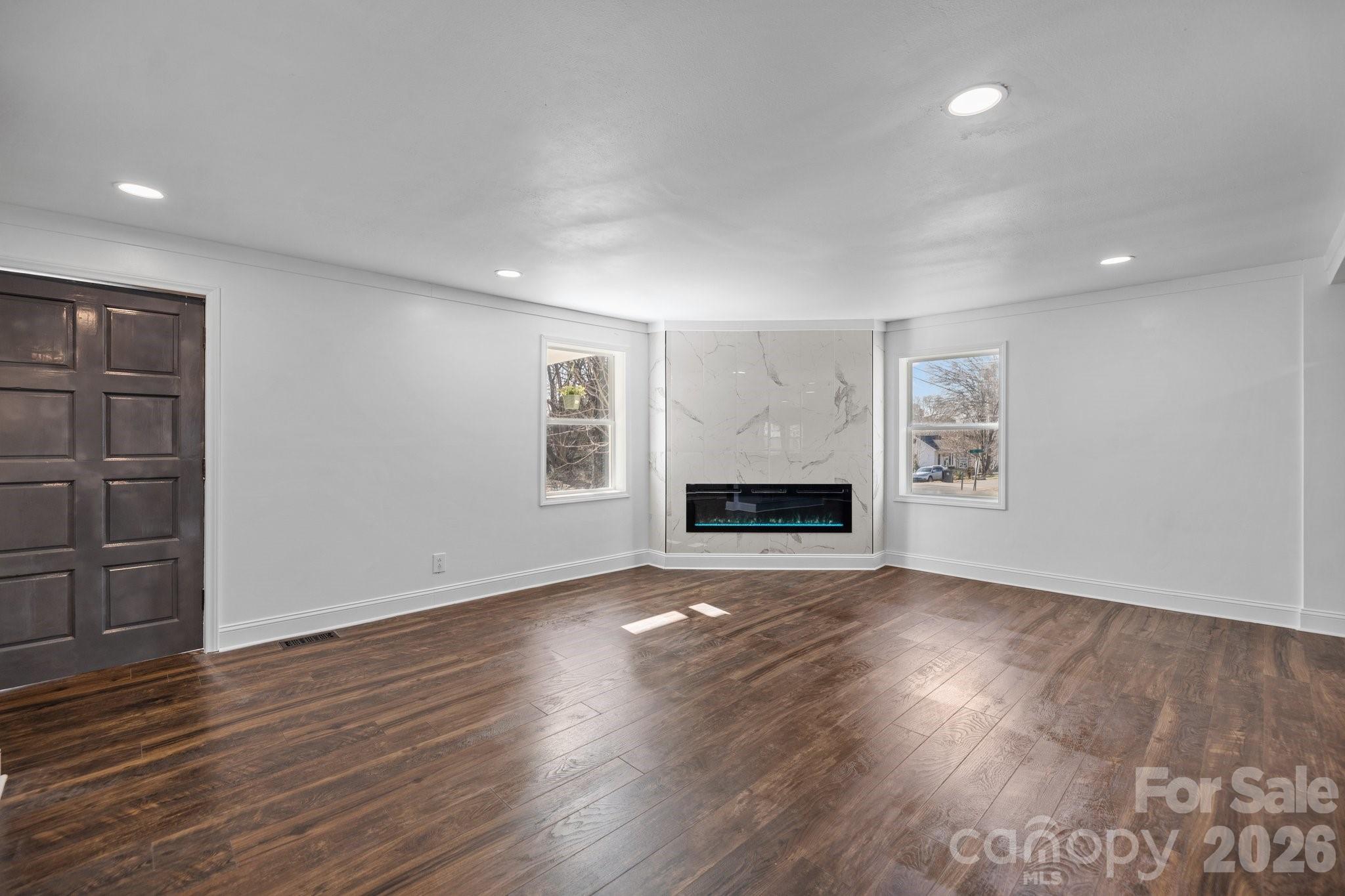 306 Ridge Street Stanley, NC 28164 - Photo 8 of 44 an empty room with wooden floor and windows