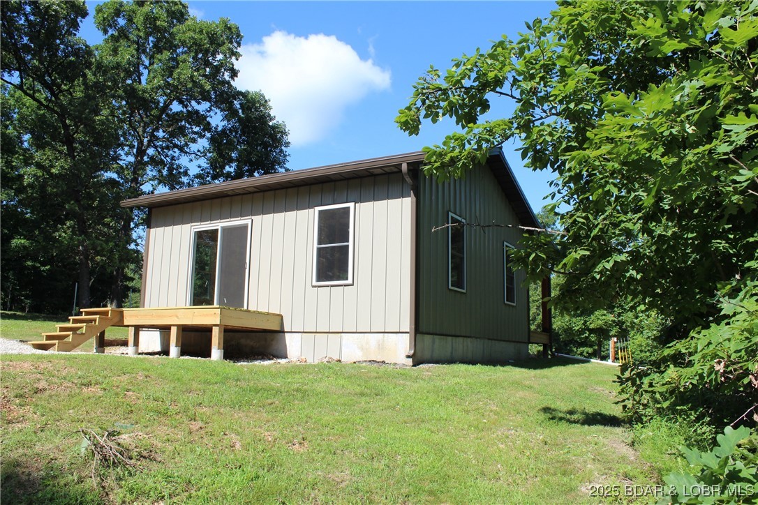 28511 Cody Road Stover, MO 65078 - Photo 5 of 26 rear of house with crawlspace access