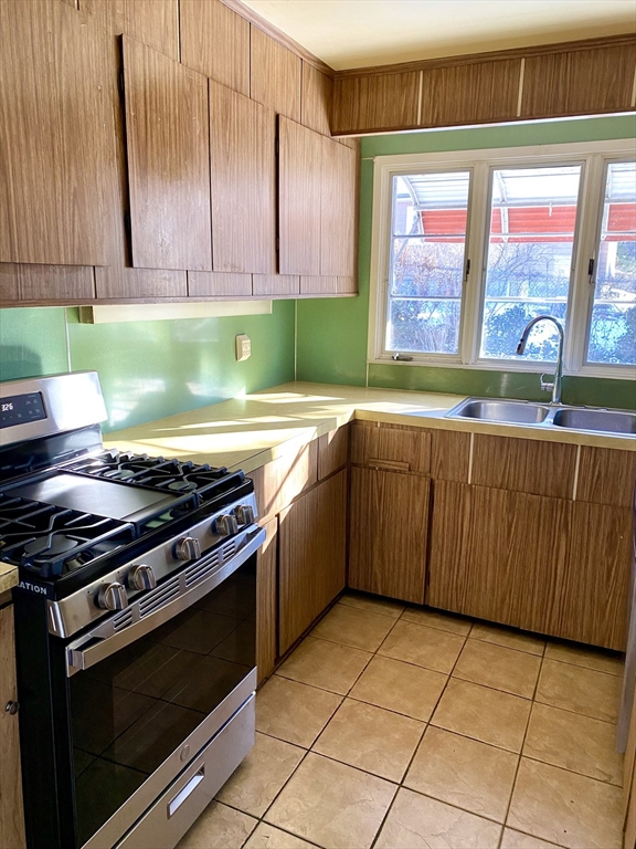 13 Deane Street Fairhaven, MA 02719 - Photo 26 of 28 a kitchen with stainless steel appliances a stove a sink and a microwave