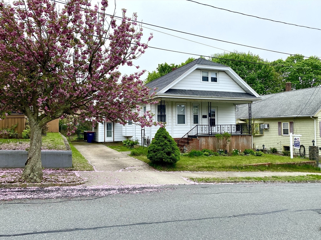 13 Deane Street Fairhaven, MA 02719 - Photo 3 of 28 a front view of a house with a yard and garage