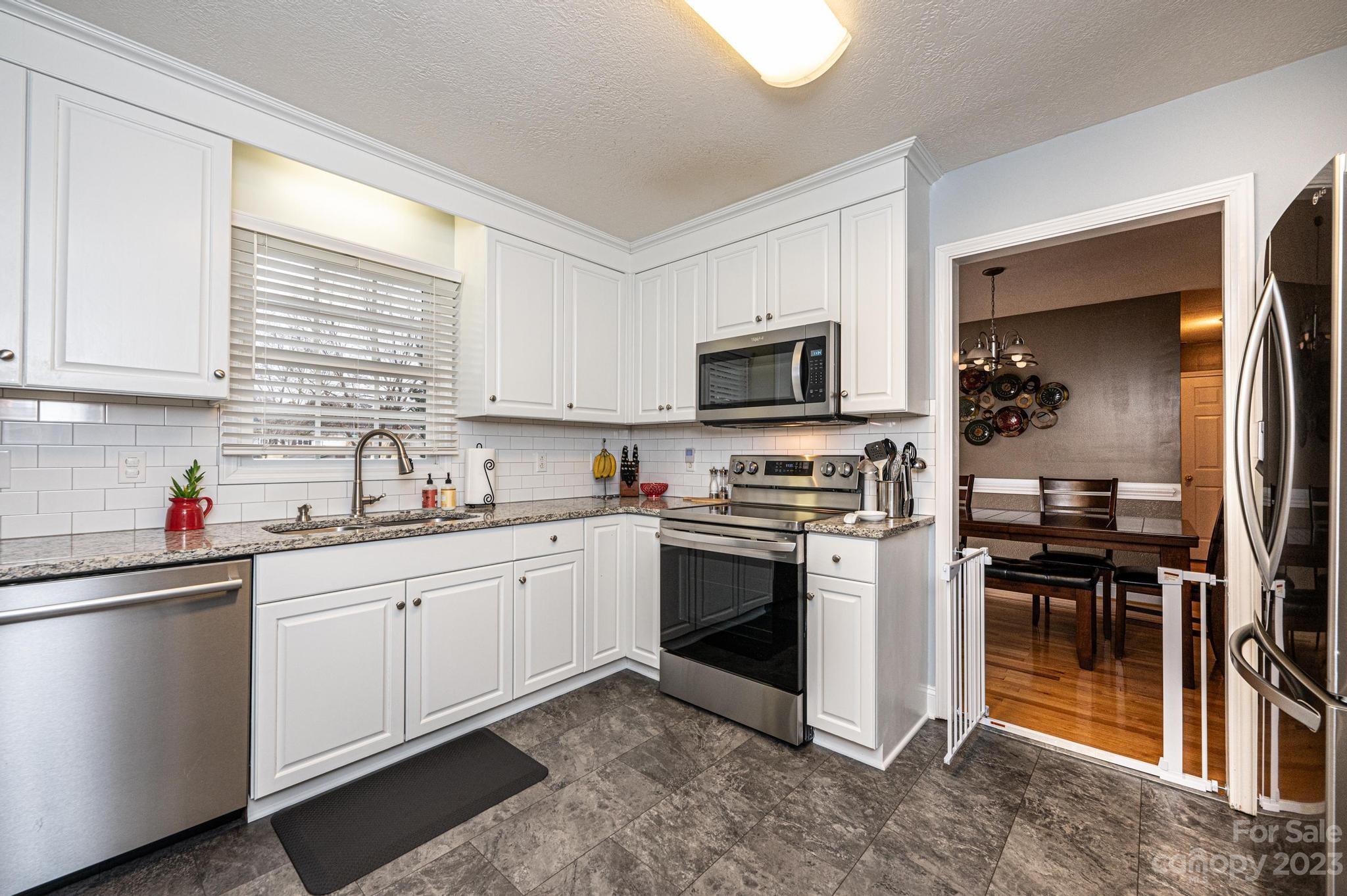 4875 Water Wheel Drive Conover, NC 28613 - Photo 12 of 33 a kitchen with sink a microwave and cabinets