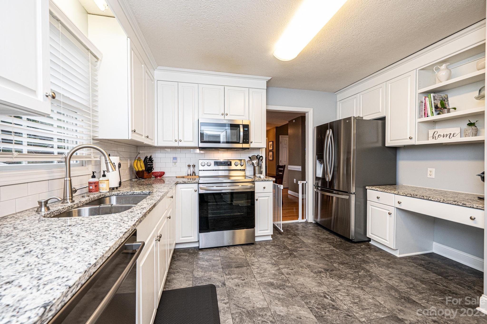 4875 Water Wheel Drive Conover, NC 28613 - Photo 13 of 33 a kitchen with stainless steel appliances granite countertop a refrigerator stove and sink