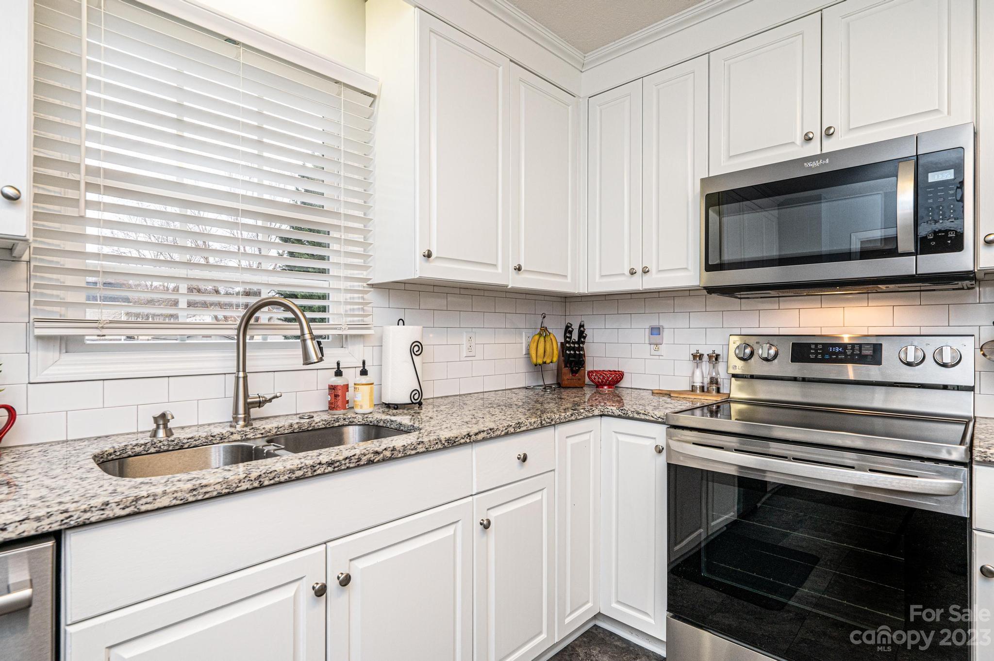 4875 Water Wheel Drive Conover, NC 28613 - Photo 14 of 33 a kitchen with granite countertop a stove a sink and a microwave