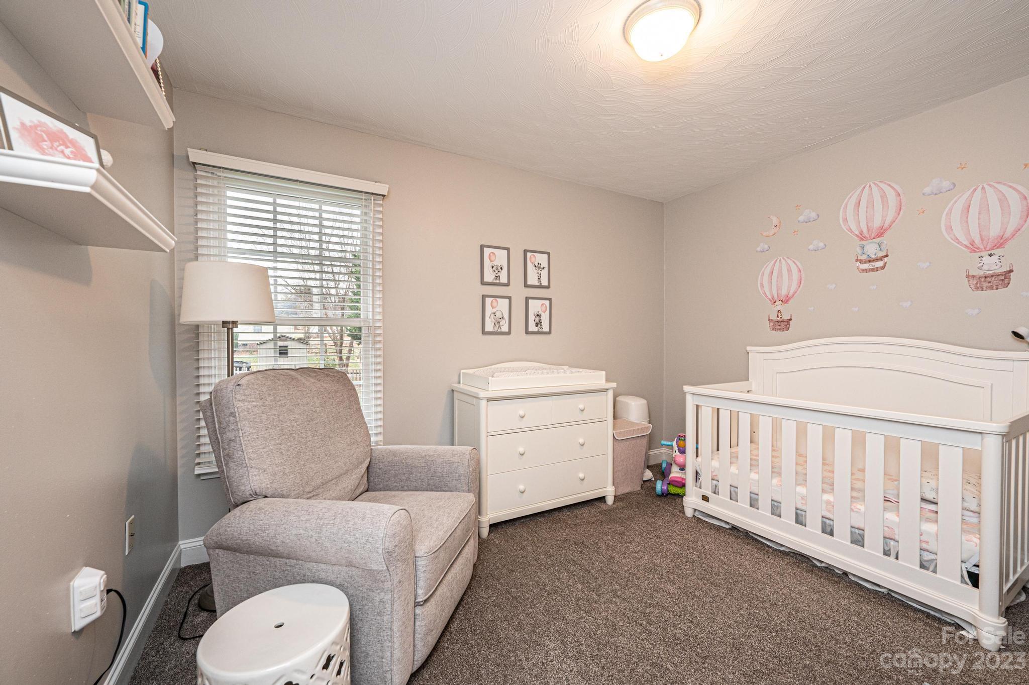 4875 Water Wheel Drive Conover, NC 28613 - Photo 20 of 33 a room with furniture a baby crib a couch and a window