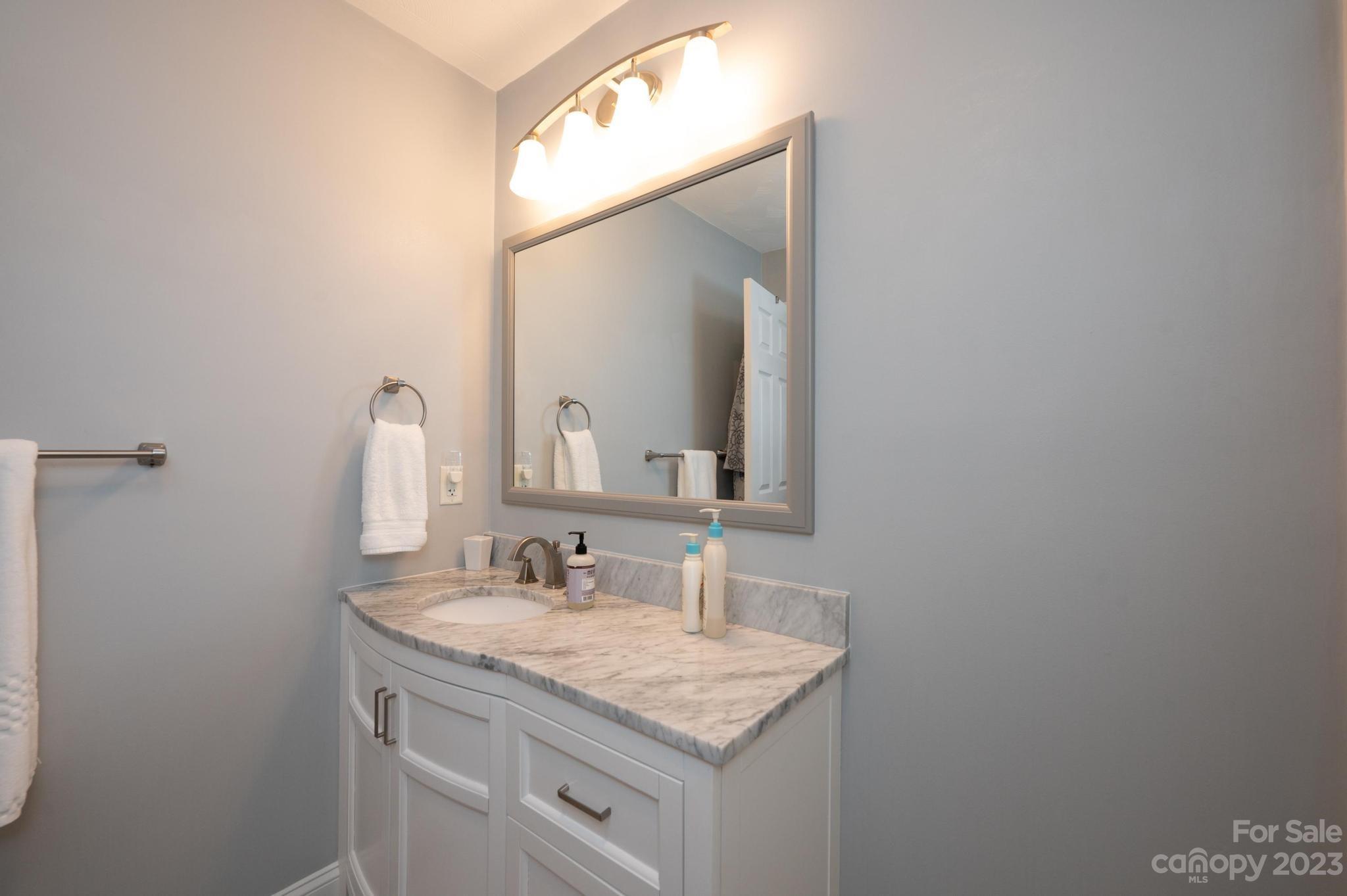4875 Water Wheel Drive Conover, NC 28613 - Photo 27 of 33 a bathroom with a granite countertop sink and a mirror