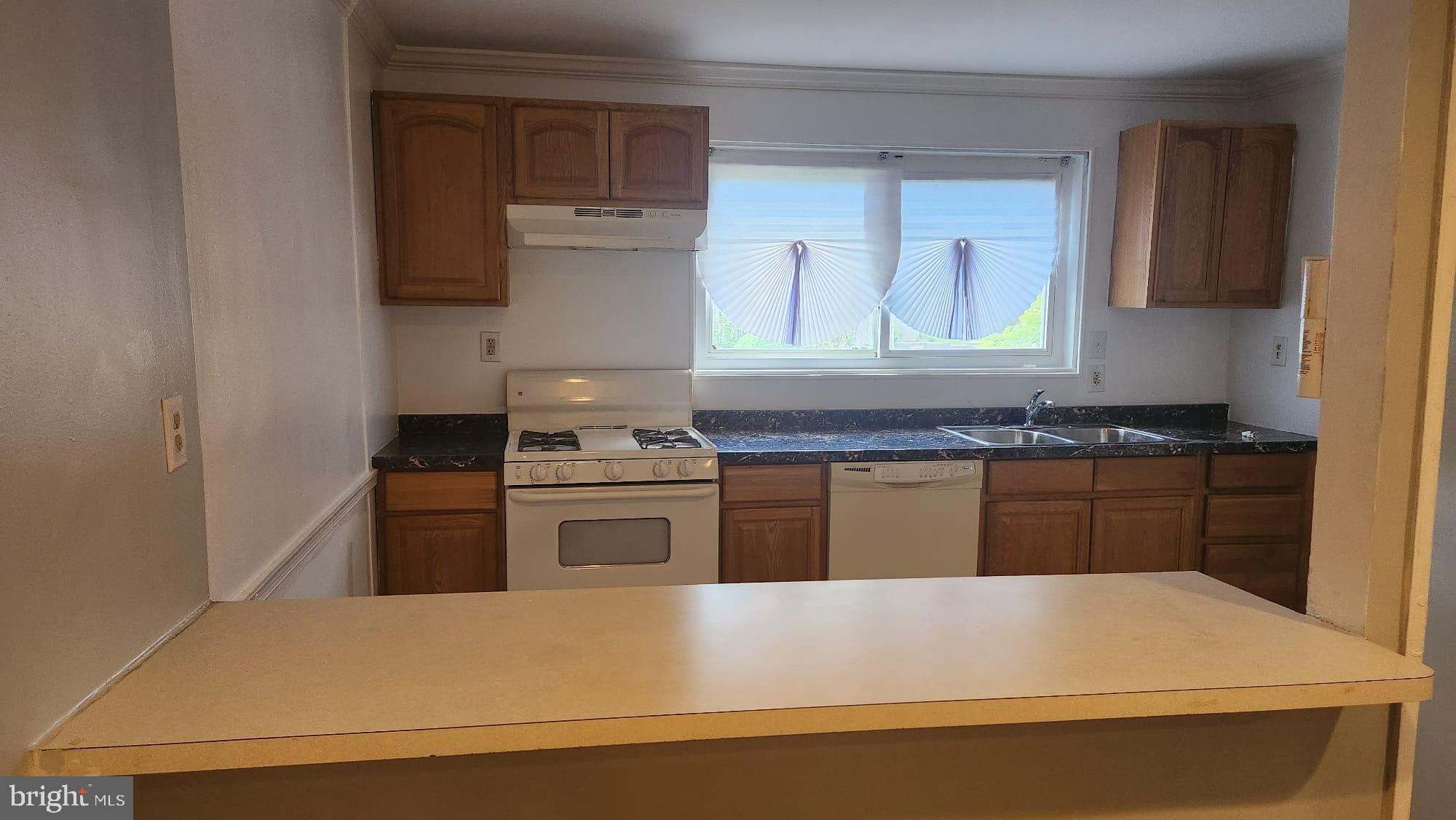 3914 28th Avenue Temple Hills, MD 20748 - Photo 18 of 28 a kitchen with kitchen island a sink stove and refrigerator