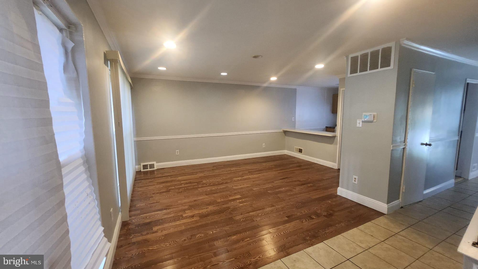 3914 28th Avenue Temple Hills, MD 20748 - Photo 19 of 28 an empty room with wooden floor and entrance