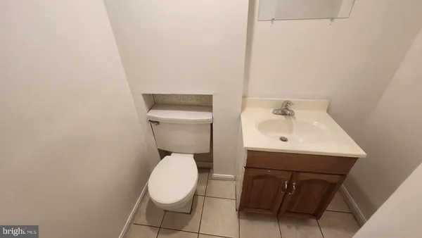 a white toilet sitting next to a white sink