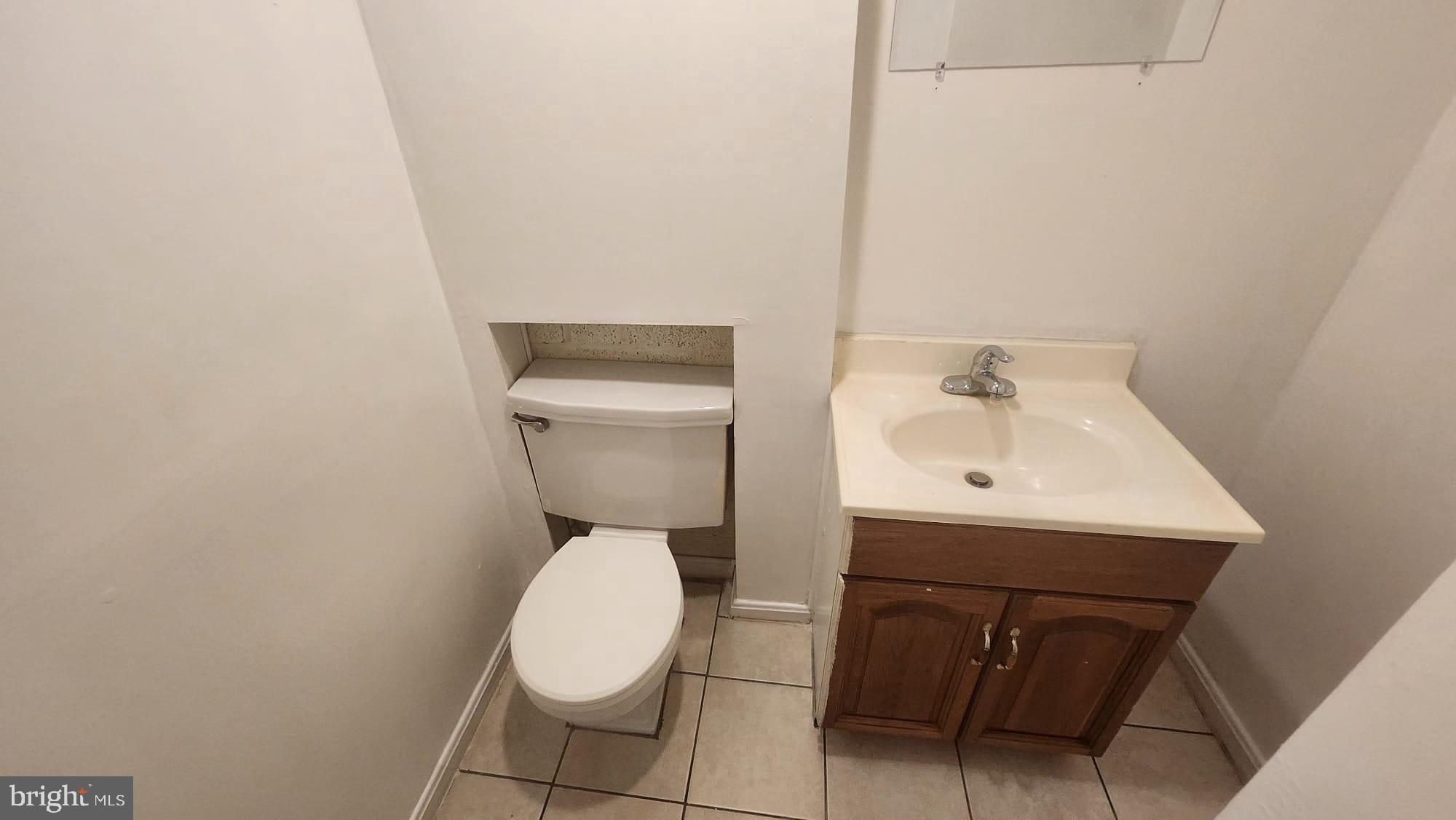 3914 28th Avenue Temple Hills, MD 20748 - Photo 3 of 28 a white toilet sitting next to a white sink