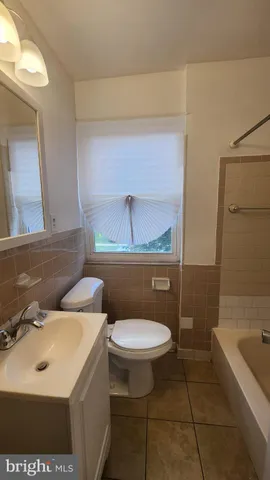 a bathroom with a sink a toilet and bathtub