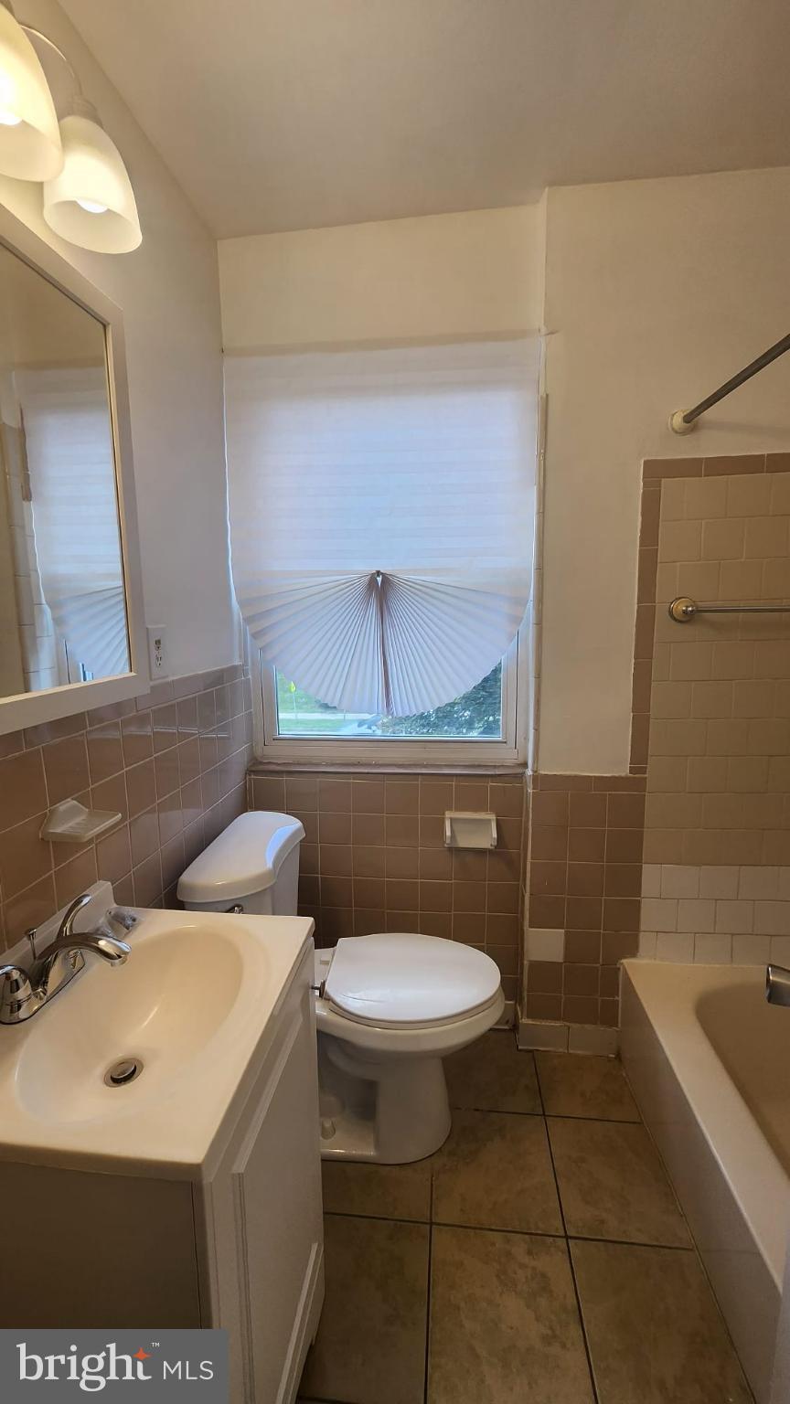 3914 28th Avenue Temple Hills, MD 20748 - Photo 10 of 28 a bathroom with a sink a toilet and bathtub
