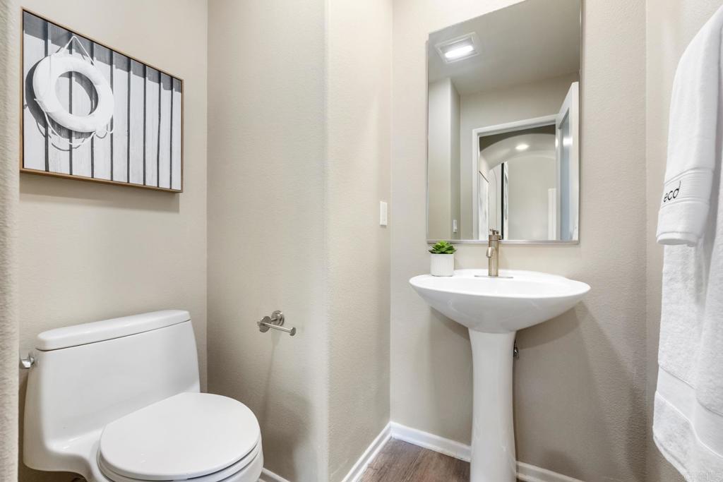 3215 Corte Poco Carlsbad, CA 92009 - Photo 22 of 25 a bathroom with a toilet sink and mirror