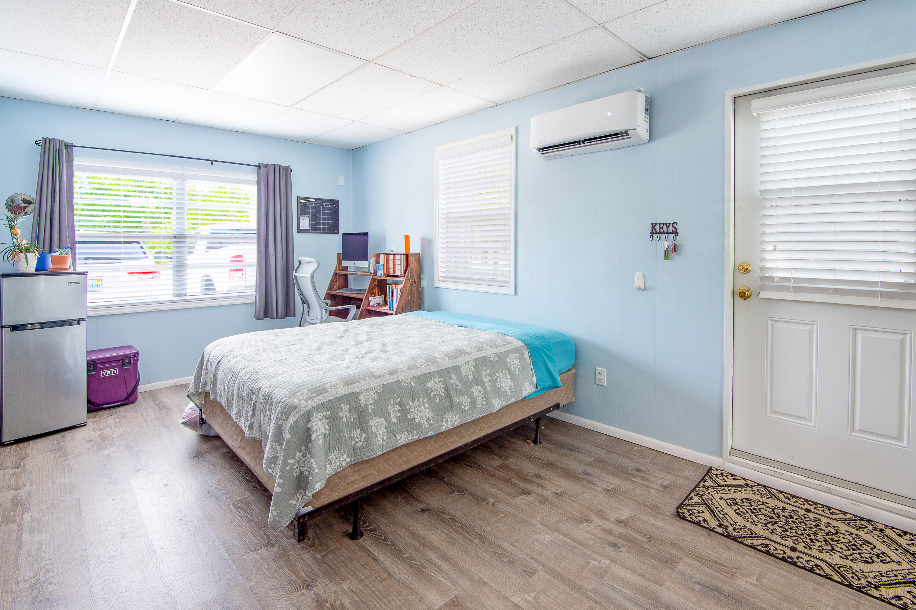 34 Key Haven Road Key West, FL 33040 - Photo 23 of 45 a bedroom with a bed wooden floor and window