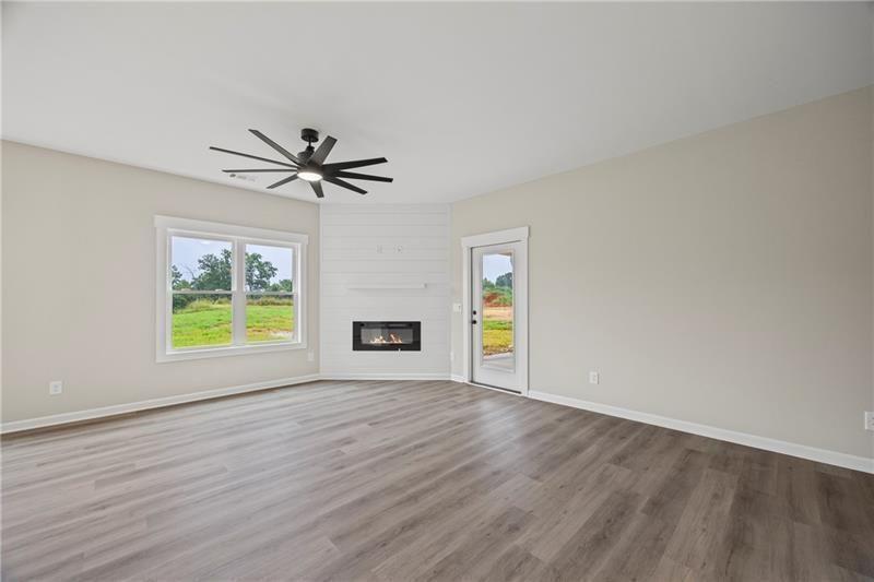 693 Racetrack Road Toccoa, GA 30577 - Photo 10 of 45 a view of an empty room with a window and wooden floor