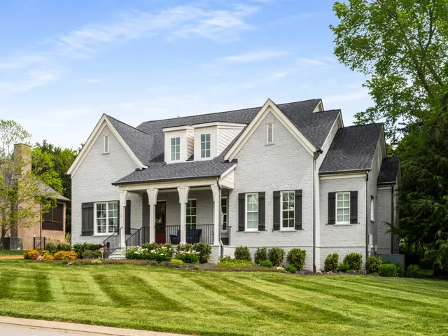 a large kitchen with stainless steel appliances kitchen island granite countertop a sink a stove and a wooden floors