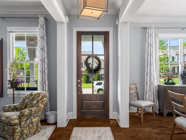 a spacious bathroom with a granite countertop sink a mirror a vanity and a shower