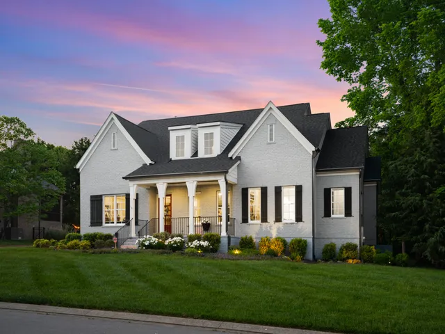 a view of a house with a garden and pathway
