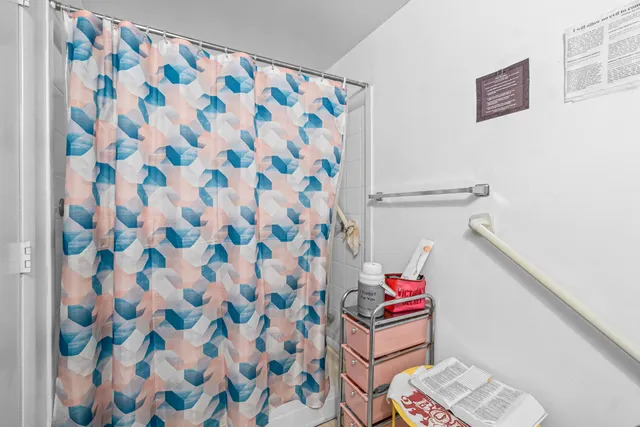 a room with a window and a shower curtain