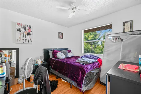 a bedroom with a bed and a chandelier