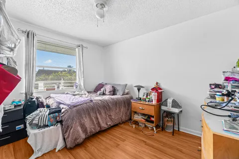 a bedroom with furniture and a wooden floor