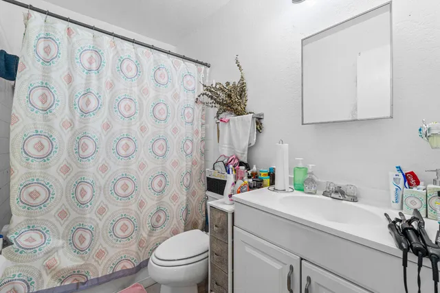 a bathroom with a sink toilet and a mirror