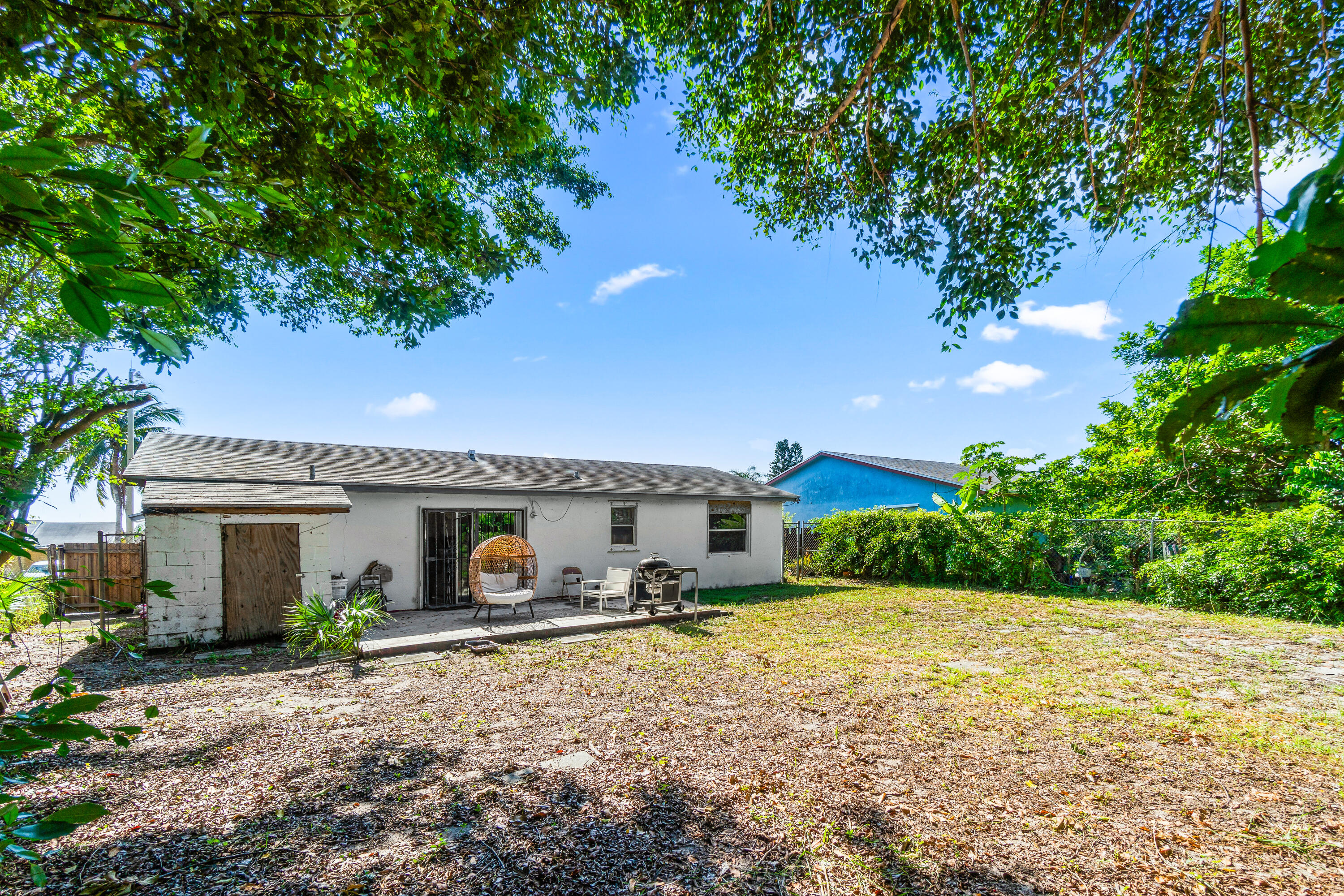2313 Z Terrace Riviera Beach, FL 33404 - Photo 19 of 21 a backyard of a house with yard and outdoor seating