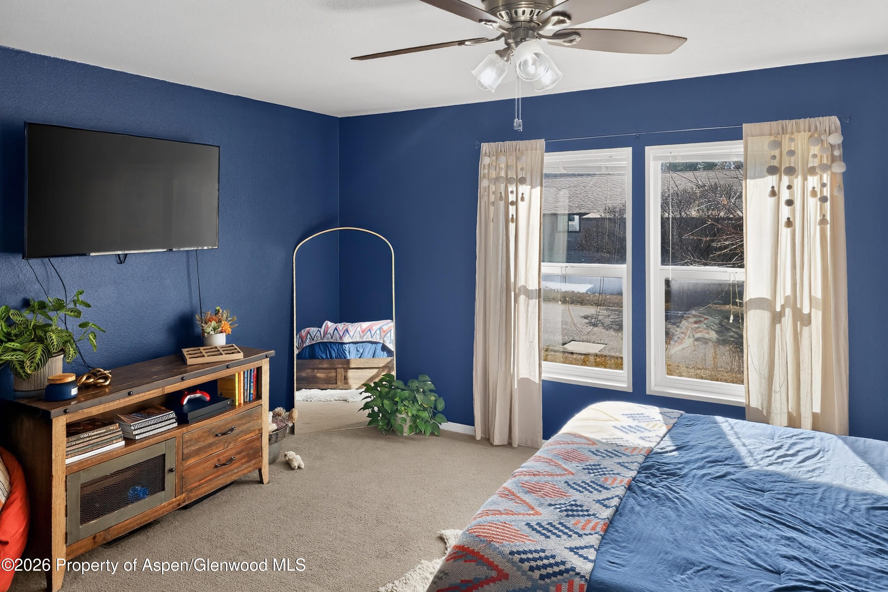 93 Remington Street Rifle, CO 81650 - Photo 13 of 25 a bedroom with furniture and a flat screen tv