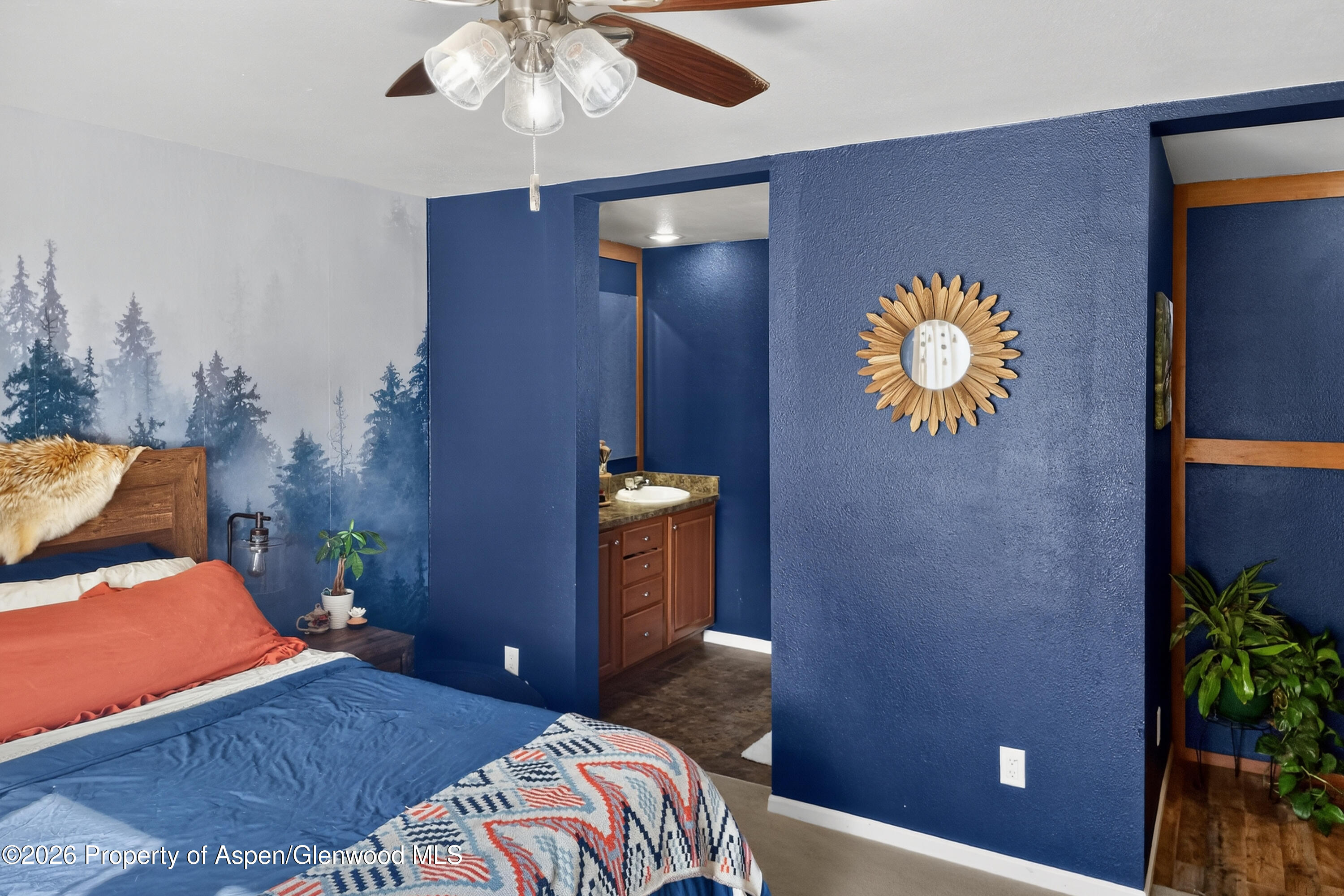 93 Remington Street Rifle, CO 81650 - Photo 14 of 25 a bedroom with a bed and a chandelier