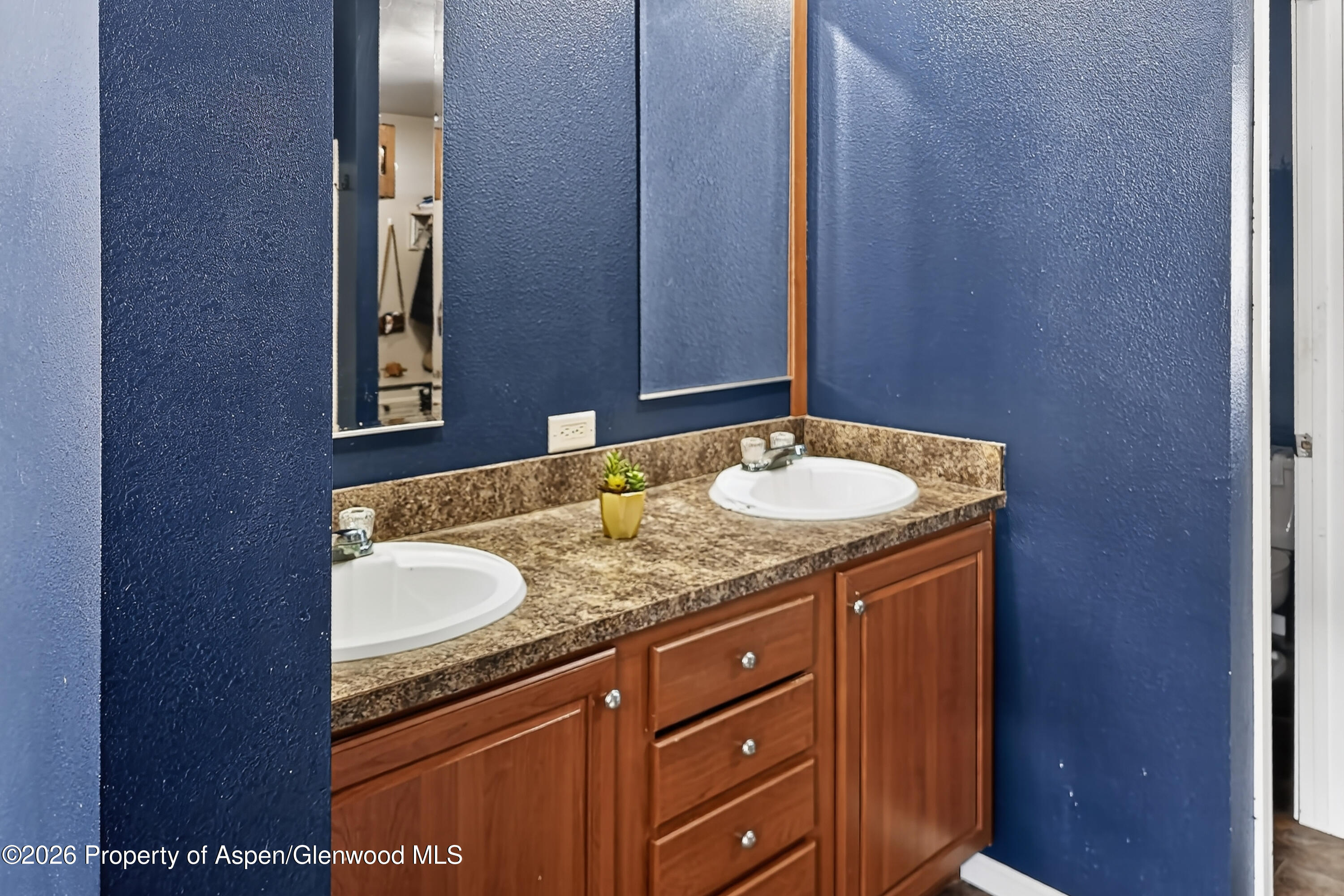 93 Remington Street Rifle, CO 81650 - Photo 16 of 25 a bathroom with a granite countertop sink and a mirror