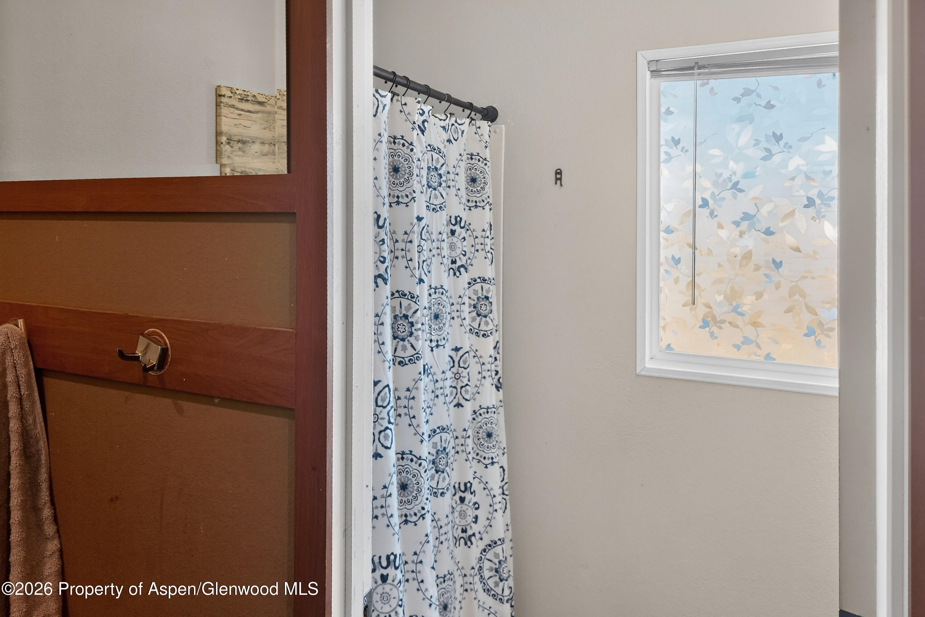 93 Remington Street Rifle, CO 81650 - Photo 17 of 25 a bathroom with a shower curtain and a window