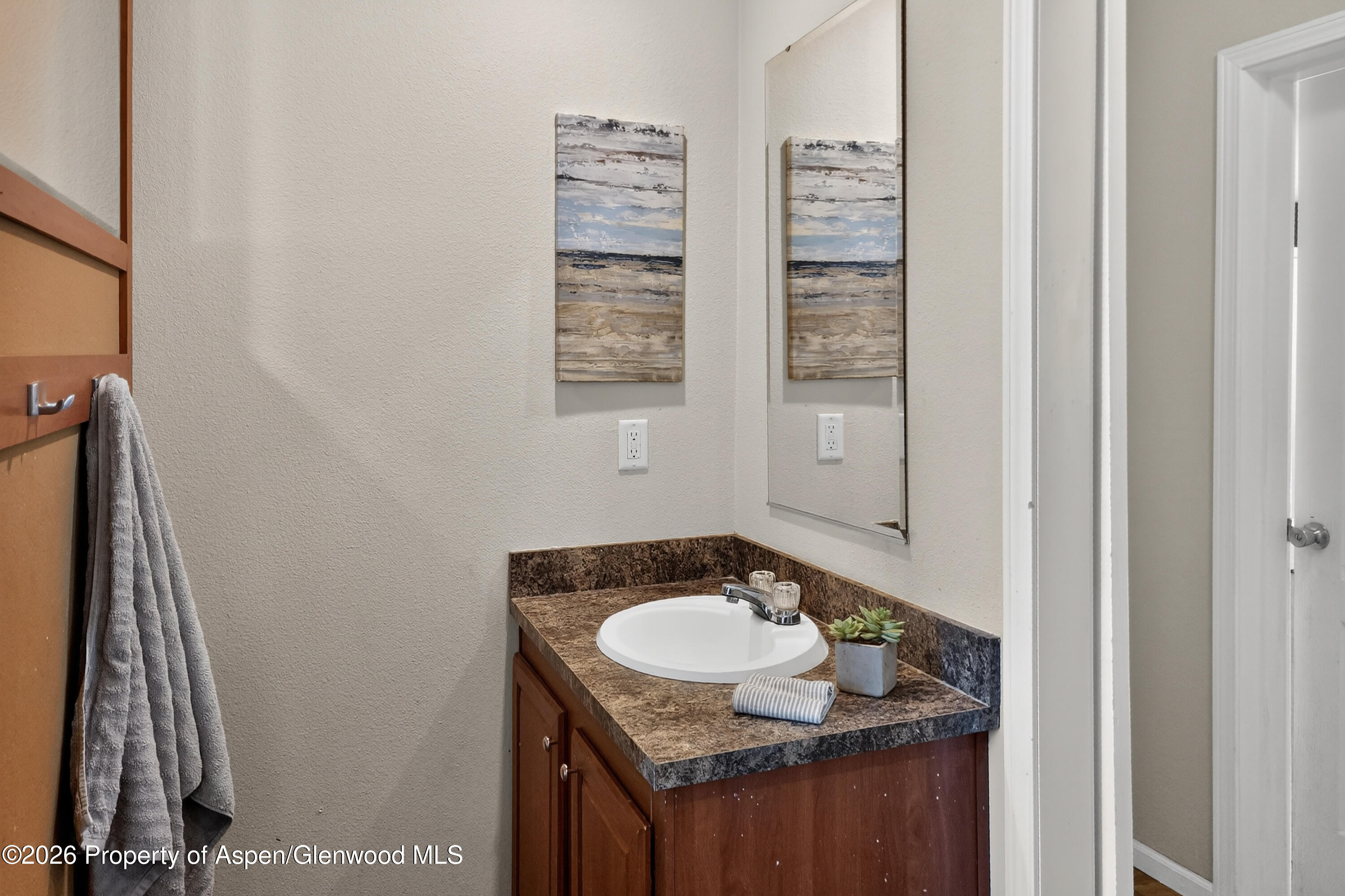 93 Remington Street Rifle, CO 81650 - Photo 19 of 25 a bathroom with a granite countertop sink and a mirror