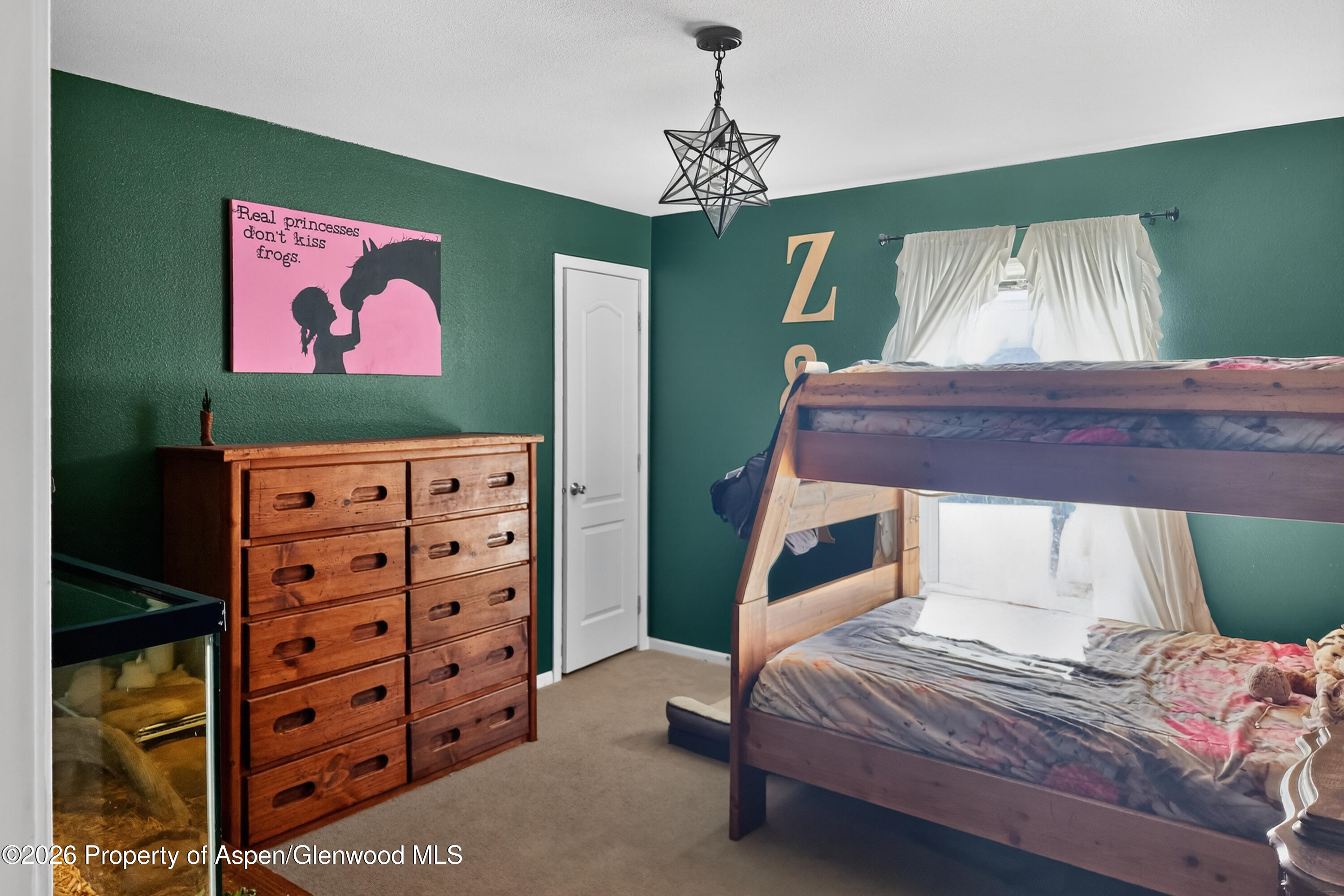 93 Remington Street Rifle, CO 81650 - Photo 21 of 25 a bedroom with a bed and a dresser