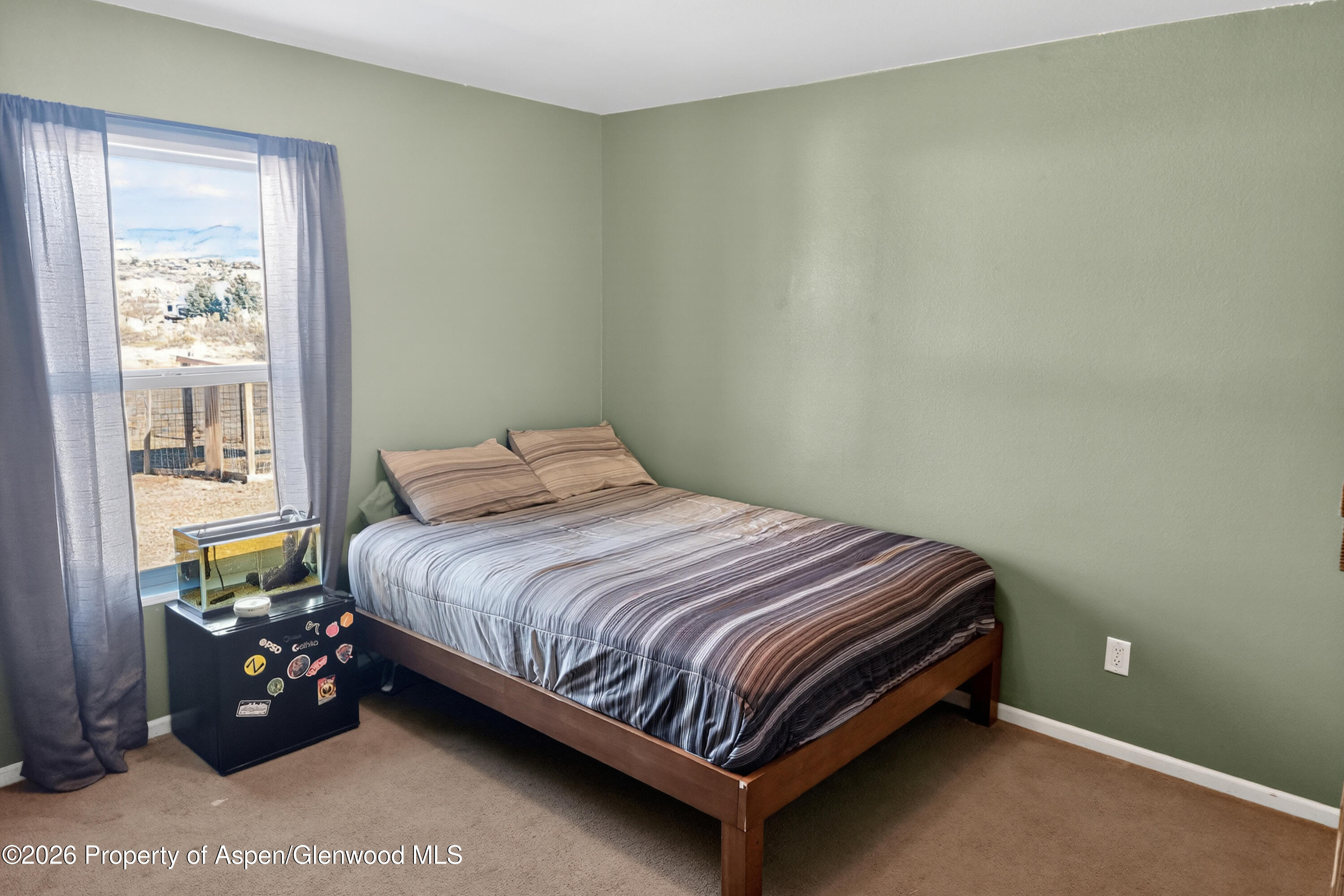 93 Remington Street Rifle, CO 81650 - Photo 22 of 25 a bed sitting in a bedroom next to a window