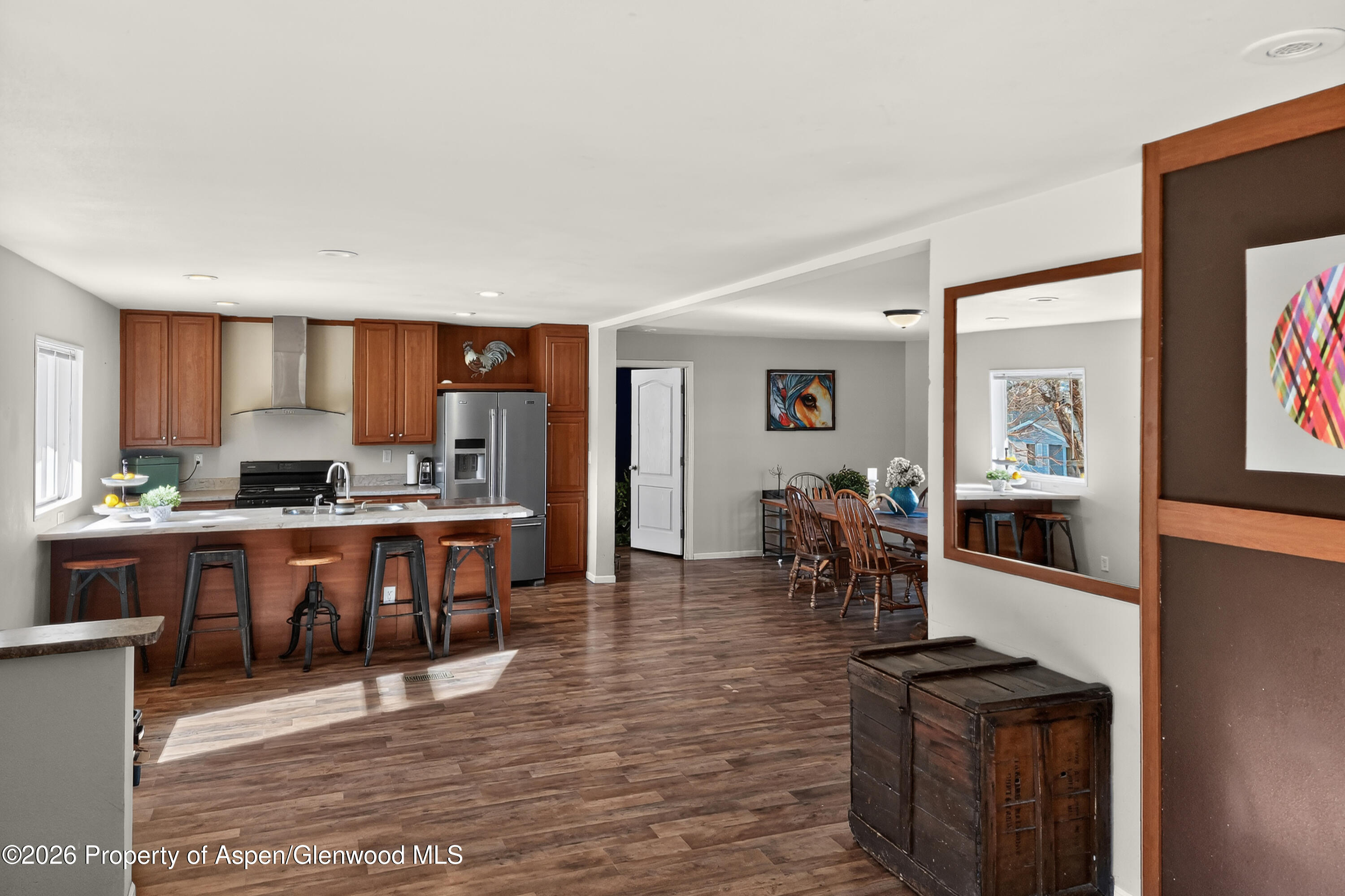 93 Remington Street Rifle, CO 81650 - Photo 3 of 25 a kitchen with stainless steel appliances kitchen island granite countertop a refrigerator stove top oven and sink