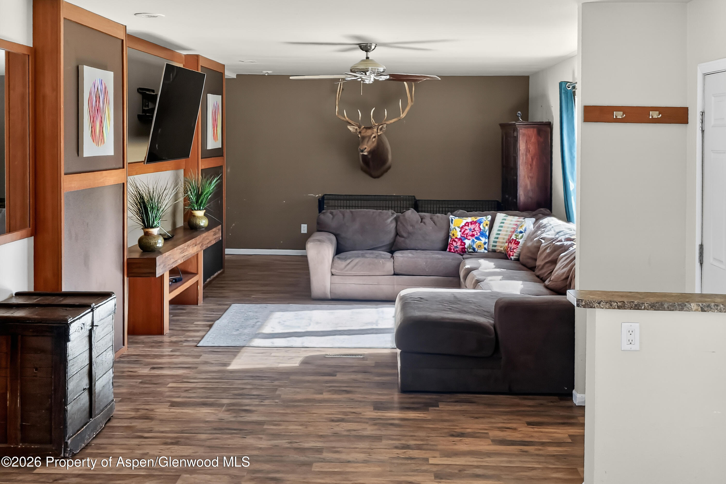 93 Remington Street Rifle, CO 81650 - Photo 9 of 25 a living room with furniture and a flat screen tv