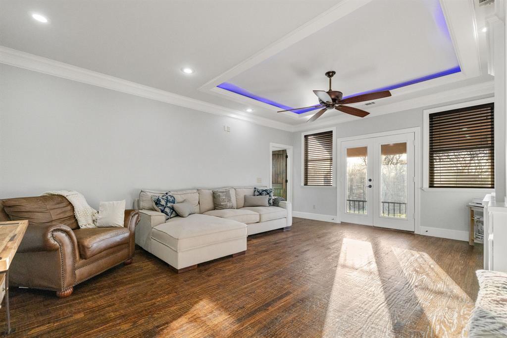 689 Jim Cannon Road Van Alstyne, TX 75495 - Photo 17 of 35 Living room with french doors, a ceiling fan, a raised ceiling, recessed lighting, and dark wood-style floors