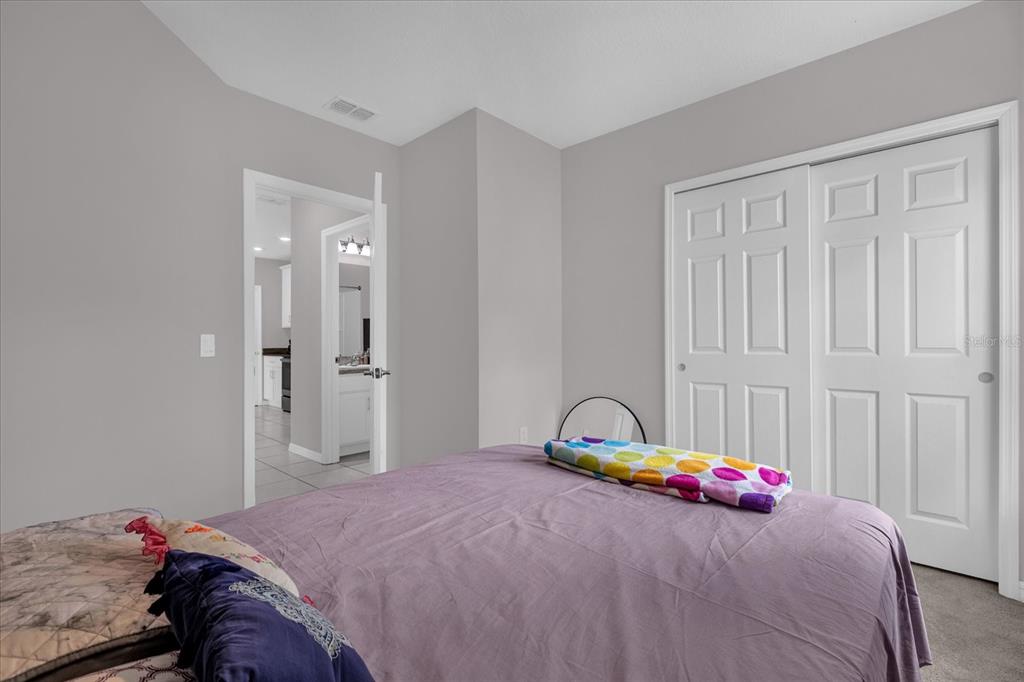 3470 Beau Road Kissimmee, FL 34746 - Photo 24 of 40 a bedroom with a bed and a window
