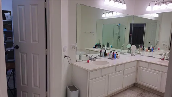 a bathroom with a sink vanity and mirror