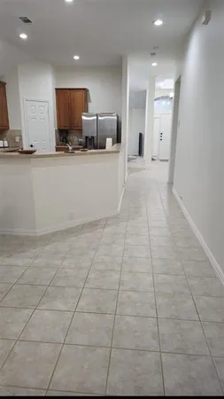 a large kitchen with a stove a sink and a microwave