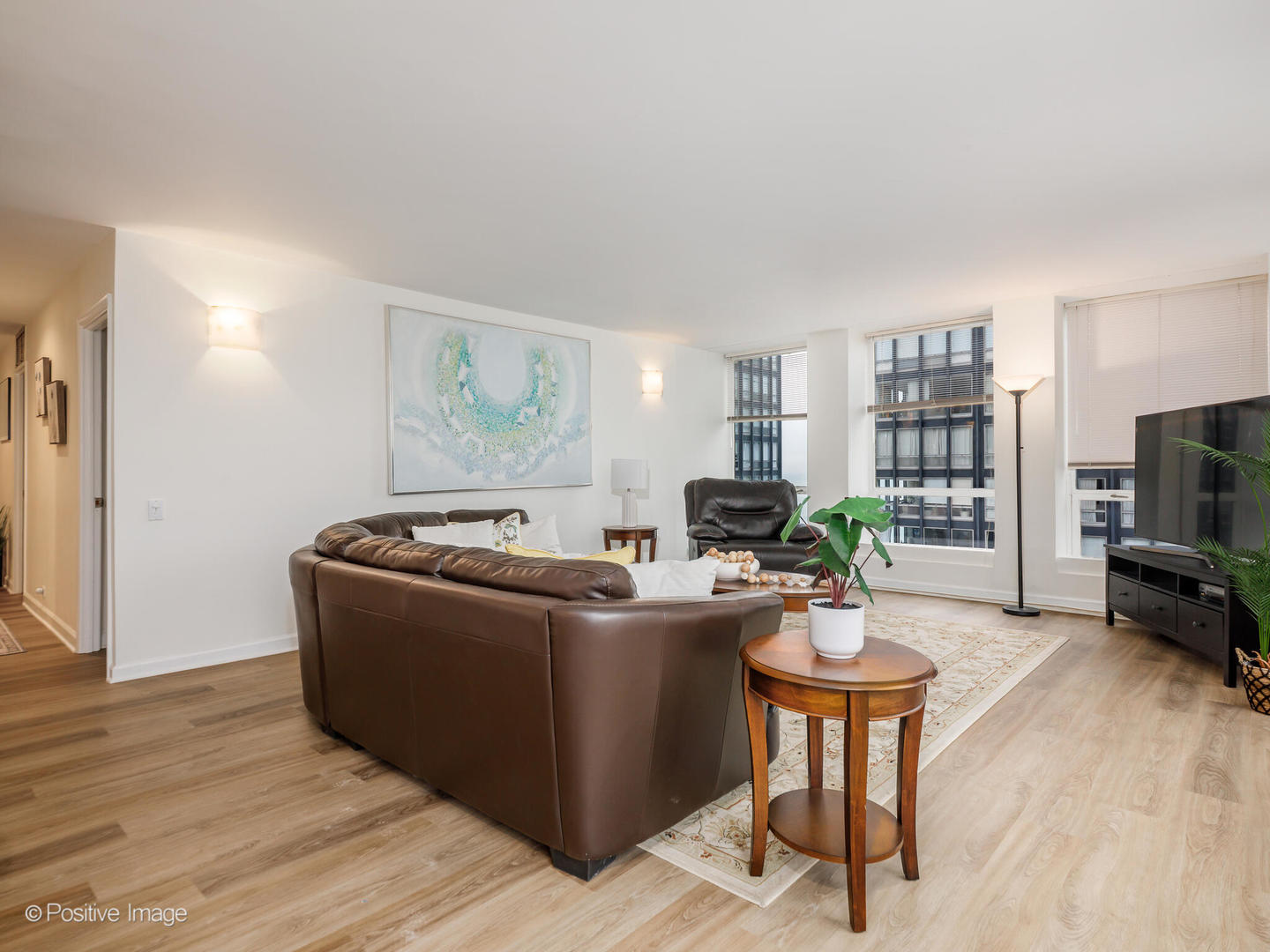 260 East Chestnut Street, Unit 2507 Chicago, IL 60611 - Photo 3 of 22 a living room with furniture a flat screen tv and a table