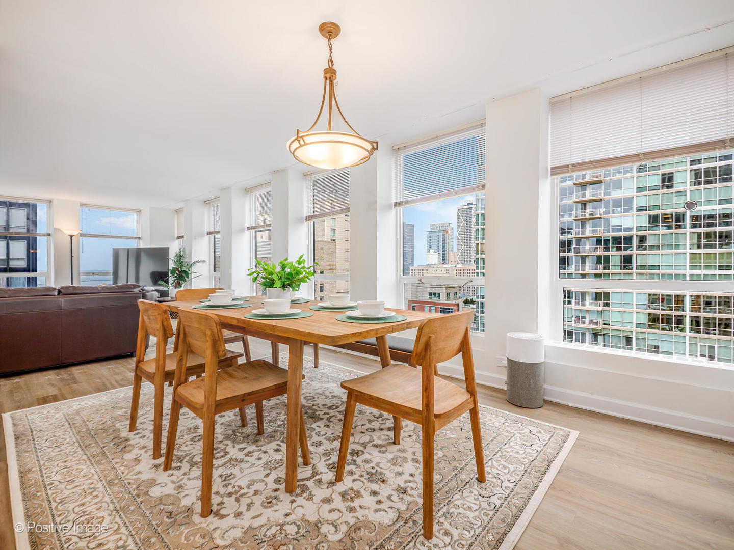 260 East Chestnut Street, Unit 2507 Chicago, IL 60611 - Photo 7 of 22 a dining room with furniture a chandelier and wooden floor