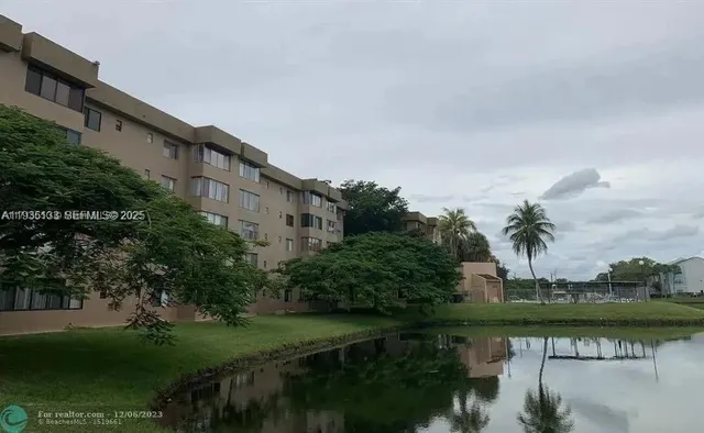 a bedroom with a bed and a large mirror on the dresser