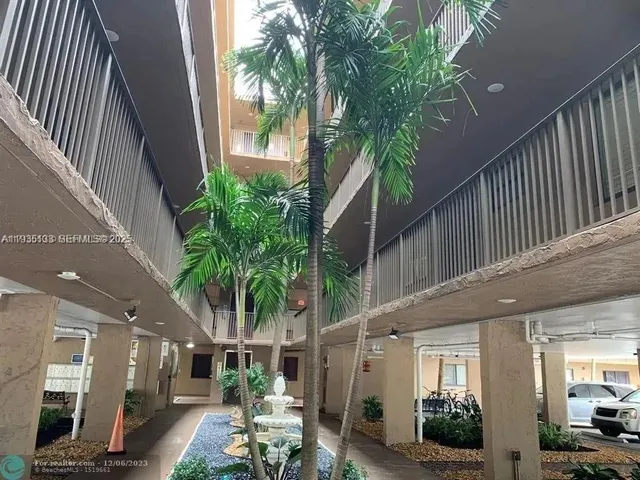 a view of a backyard with plants and a patio