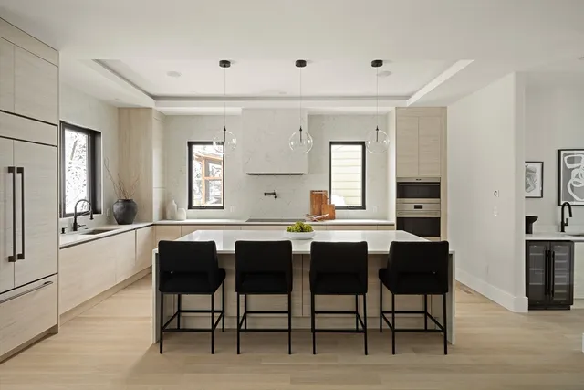 a kitchen with stainless steel appliances granite countertop a sink and a refrigerator