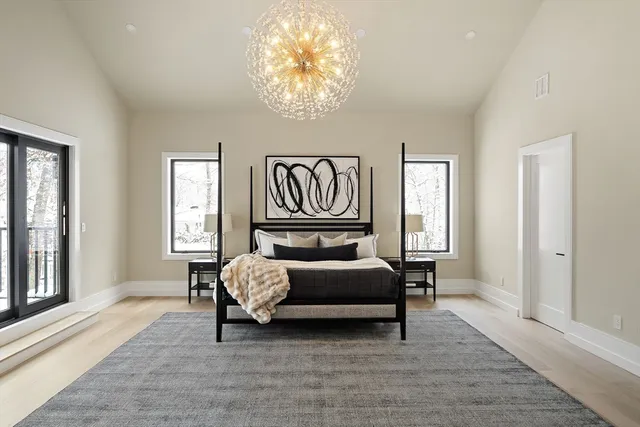 a spacious bedroom with a bed and a large window